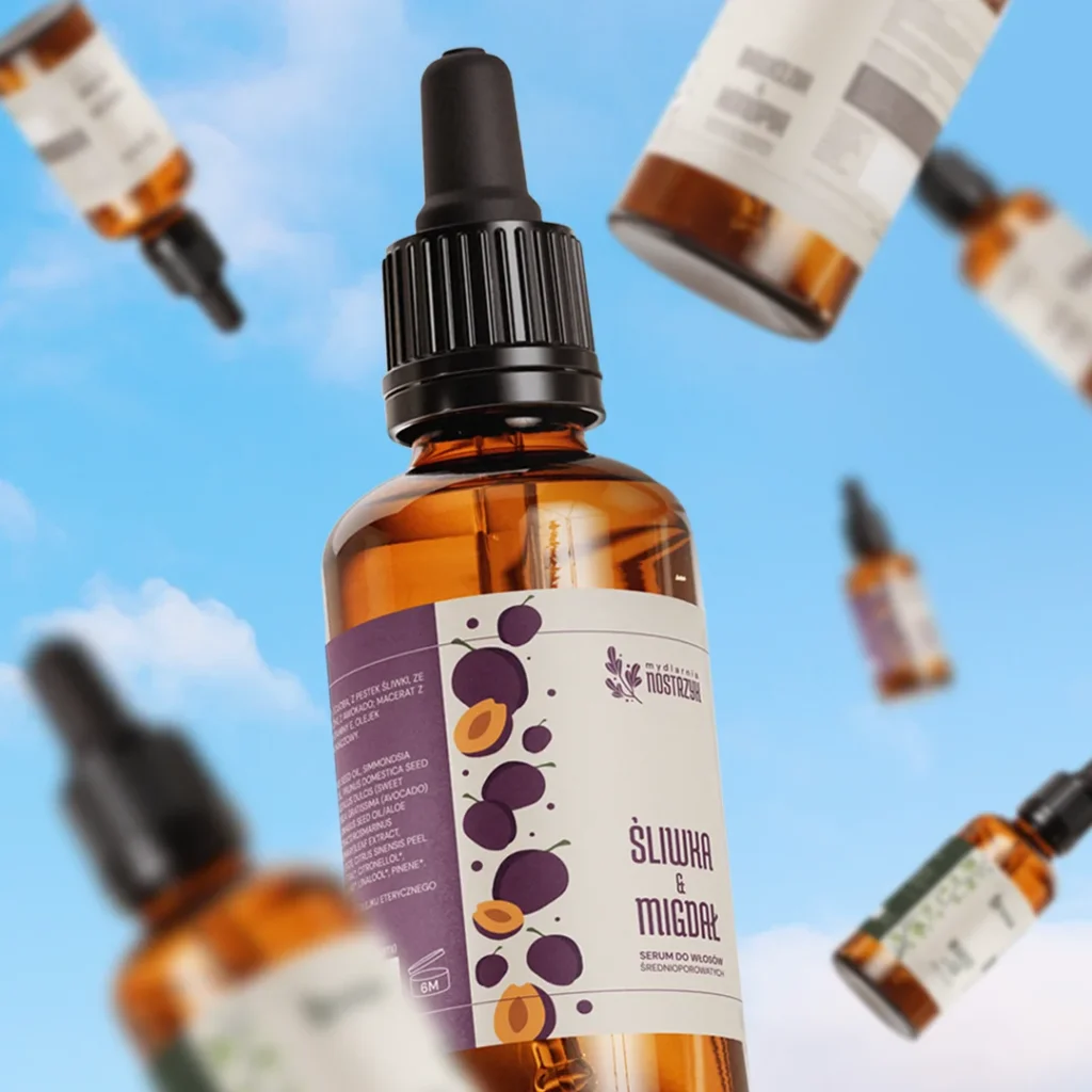 Olejki w butelkach z pipetą na tle nieba.